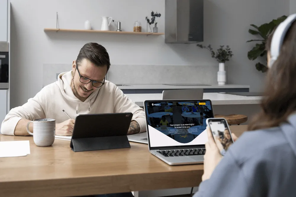 Trispacehub website viewing on laptop and mobile with person